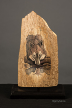 A scrimshaw peice by Ginny Hall 						 		depicting a wolf drinking.