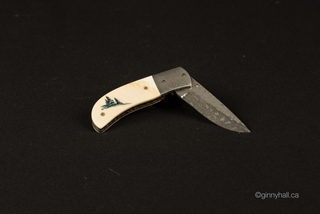 A scrimshaw peice by Ginny Hall 						 		shwoing a collaboration with Hatt Knives.