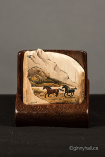 A scrimshaw peice by Ginny Hall 						 		depicting running horses.