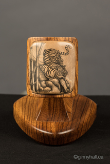 A scrimshaw peice by Ginny Hall 						 		depicting a tiger.